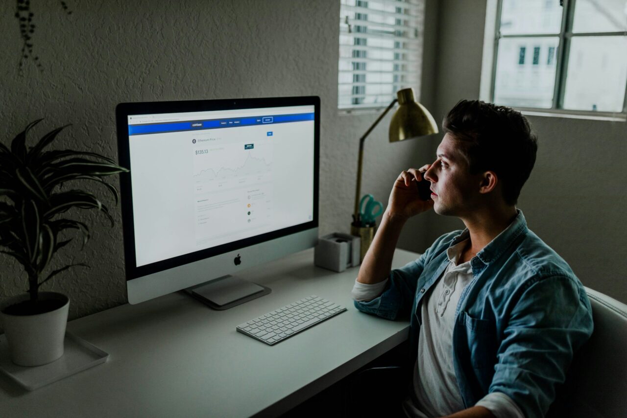Online business man with phone and computer